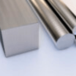 Close-up image of metal bars, including a square-shaped bar on the left and round cylindrical rods on the right, placed on a flat surface.